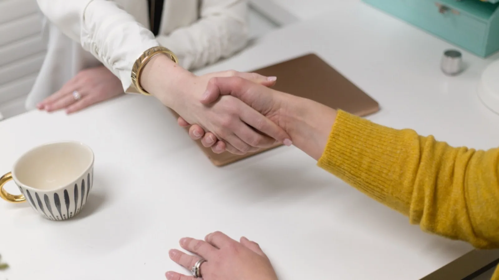A partnership handshake in an office