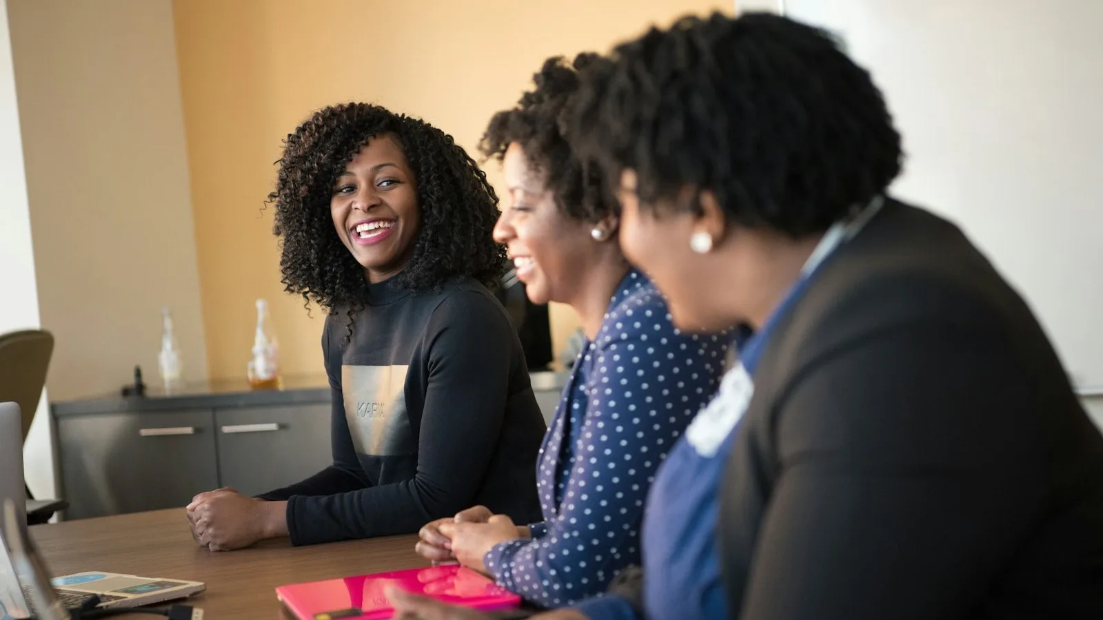 Colleagues in conversation at a table